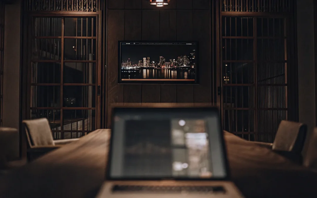 Business video management software on laptop in conference room.