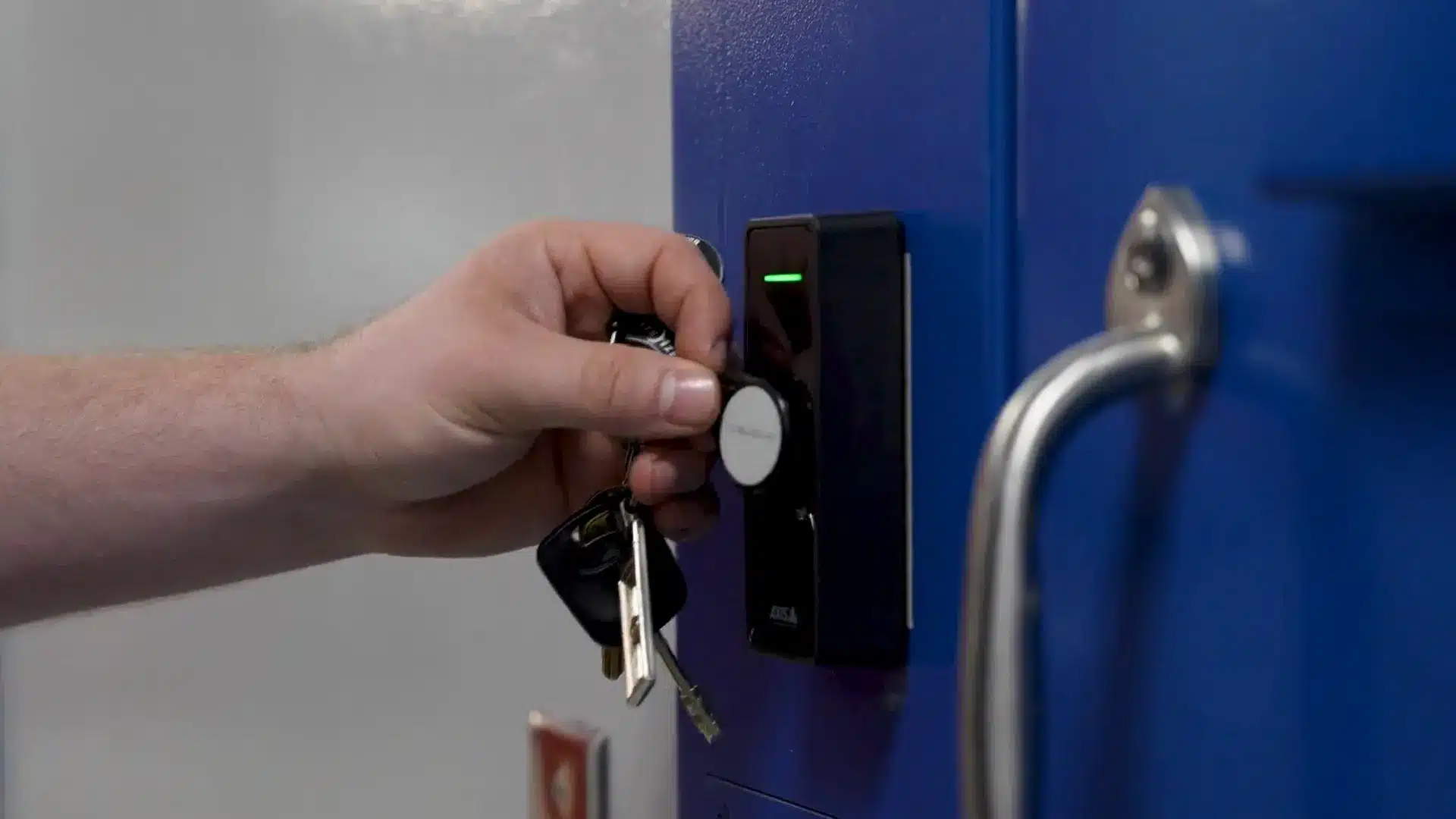 Wilmington Police and City Hall Security Modernization 8 Key fob credential being read by a new access control reader on a secure interior door
